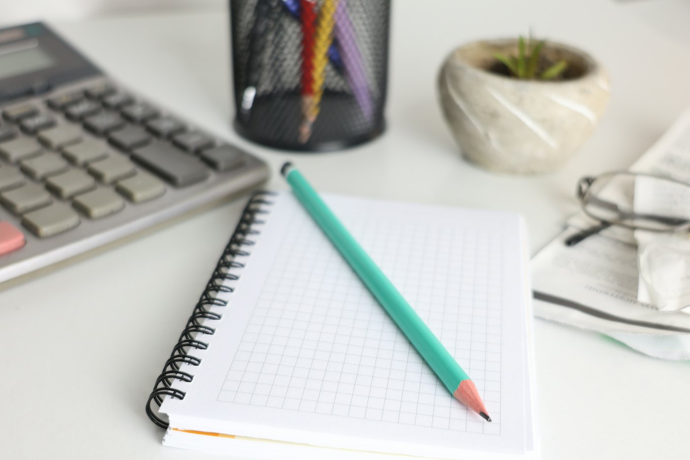 Calculator, notebook and pencil on an accounting desk
